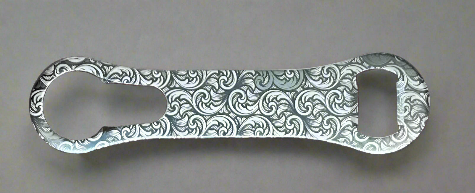 Decorative bottle opener with intricate patterns on a gray background
